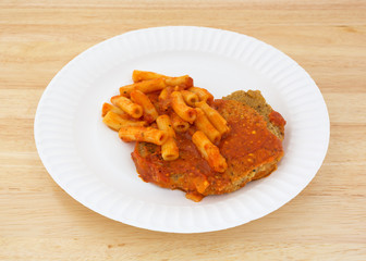 Breaded chicken with pasta in tomato sauce