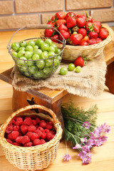 Fresh berries in basket on wall background