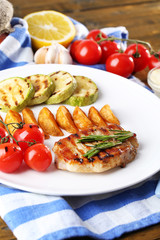 Grilled steak, grilled vegetables and fried potato pieces