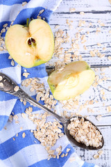 Obraz na płótnie Canvas Apple with oatmeal and vintage spoons