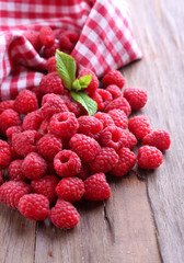 Ripe sweet raspberries on table close-up