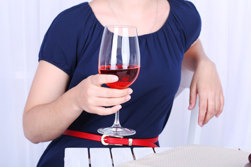 Young woman with glass of red wine