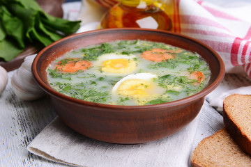 Delicious green soup with sorrel on table close-up