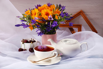 Cup of fresh herbal tea on table