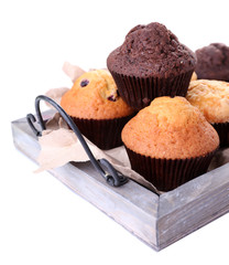 Tasty muffins on wooden tray isolated on white
