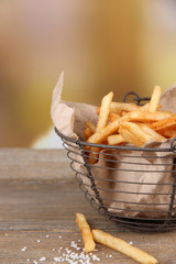Tasty french fries in metal basket