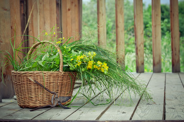 Basket of wild flowers and grass and old pruning shears on count