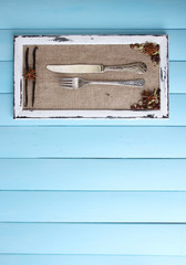 Wooden frame, spices and vintage cutlery