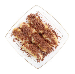 Sweetened fried banana on plate, isolated on white