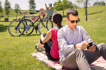 Couple in love using a smartphones on the park