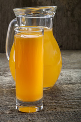 A refreshing orange juice on rustic wooden background