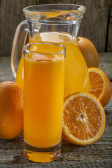 A refreshing orange juice on rustic wooden background