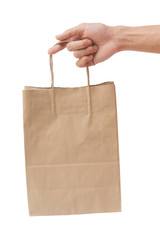 Hand holding and giving paper bag isolated over white background