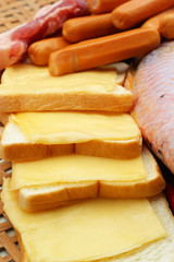 cheese the place on a slice of bread and sausage.