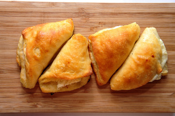 Pastry buns with cheese filling on a cutting board
