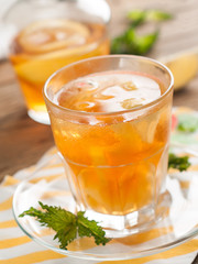Iced tea with lemon slices, selective focus