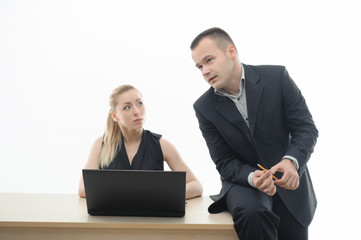 Colleagues discussing something sitting by computer