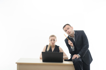 Colleagues discussing something sitting by computer