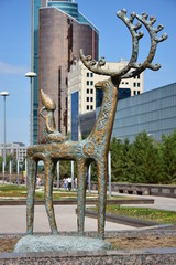 Statue featuring an elk with a child on back