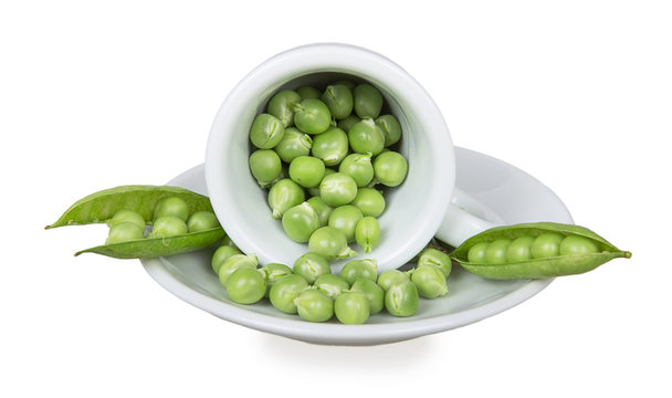 Fresh green peas in an inverted white cup