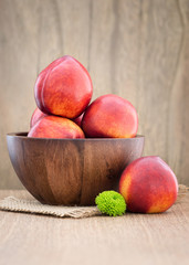 Juicy fresh peaches on  wooden background