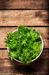 Fresh green salad in a bowl on  wooden background - Lettuce Sala