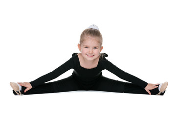 Pretty little girl performs gymnastic exercise