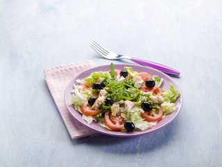 salad with fresh tuna lettuce tomato arugula and olives