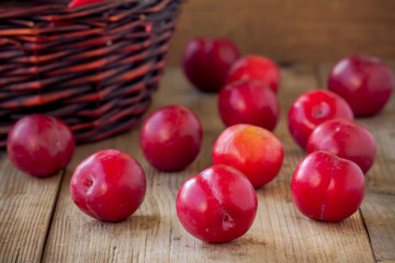 red plums on old wooden background