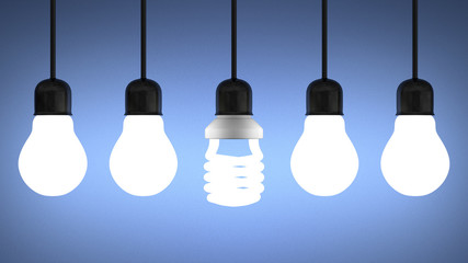 Glowing spiral light bulb hanging among tungsten ones on blue