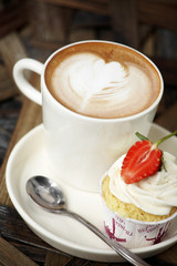 close up hot latte and cream in white cup