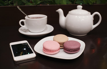 Tea and macaroons with a tablet computer