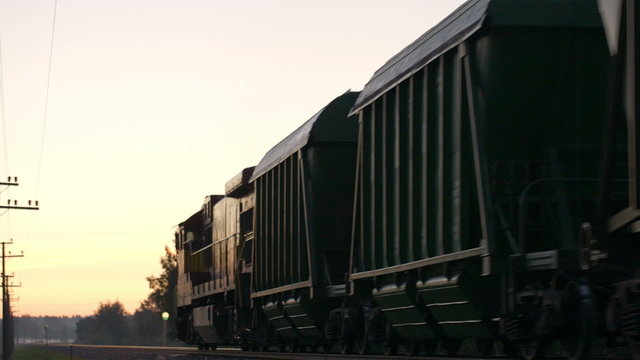 Freight train passing by in the countryside.