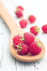 raspberries on wooden spoon