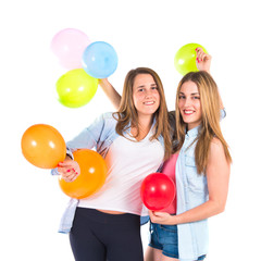 Friends with many balloons over white background