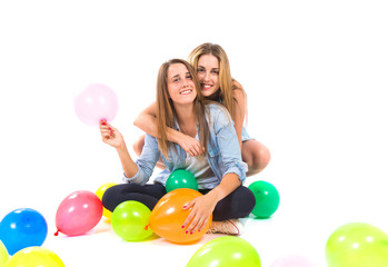 Fototapeta na wymiar Friends with many balloons over white background