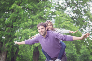 Father and Girl flying in the Park