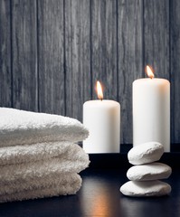 Obraz na płótnie Canvas Spa massage border with towel stacked.candles and stone