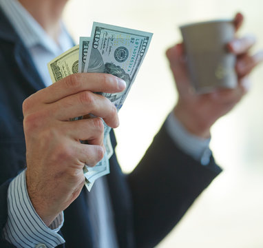 Businessman holding money in his hands