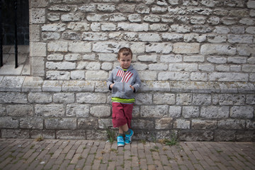 cute boy in front of wall
