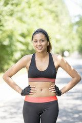 Fototapeta premium Portrait of athletic smiling young woman, outdoor.