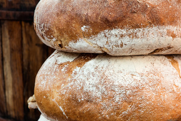 Couple loafs of  bread lying near barrel