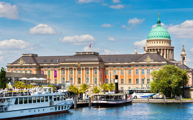 Fototapeta premium Dock for excursion steamers on the pier in Potsdam with the Brandenburg State Parliament building in the background