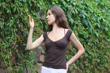 Fototapeta premium Beautiful Girl Enjoying Nature. Young Woman Contemplate Plant.