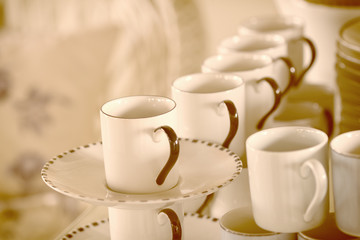 Fototapeta na wymiar Stacked empty tea cups vintage style