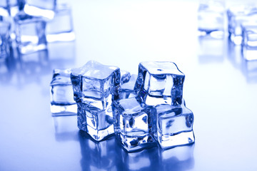 Ice cubes on blue background 