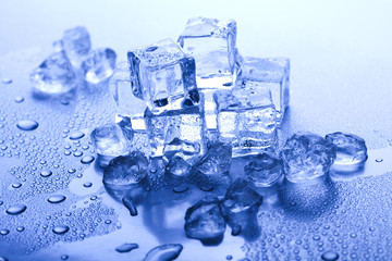 Ice cubes on blue background 