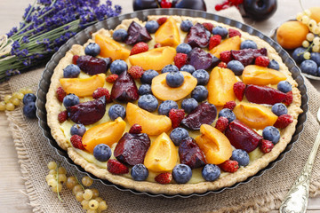 Sweet tart with peaches, plums and blueberries