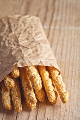 bread sticks grissini with sesame seeds in craft pack