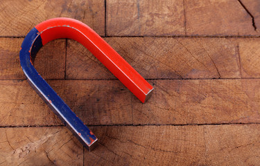 Magnet on color wooden background